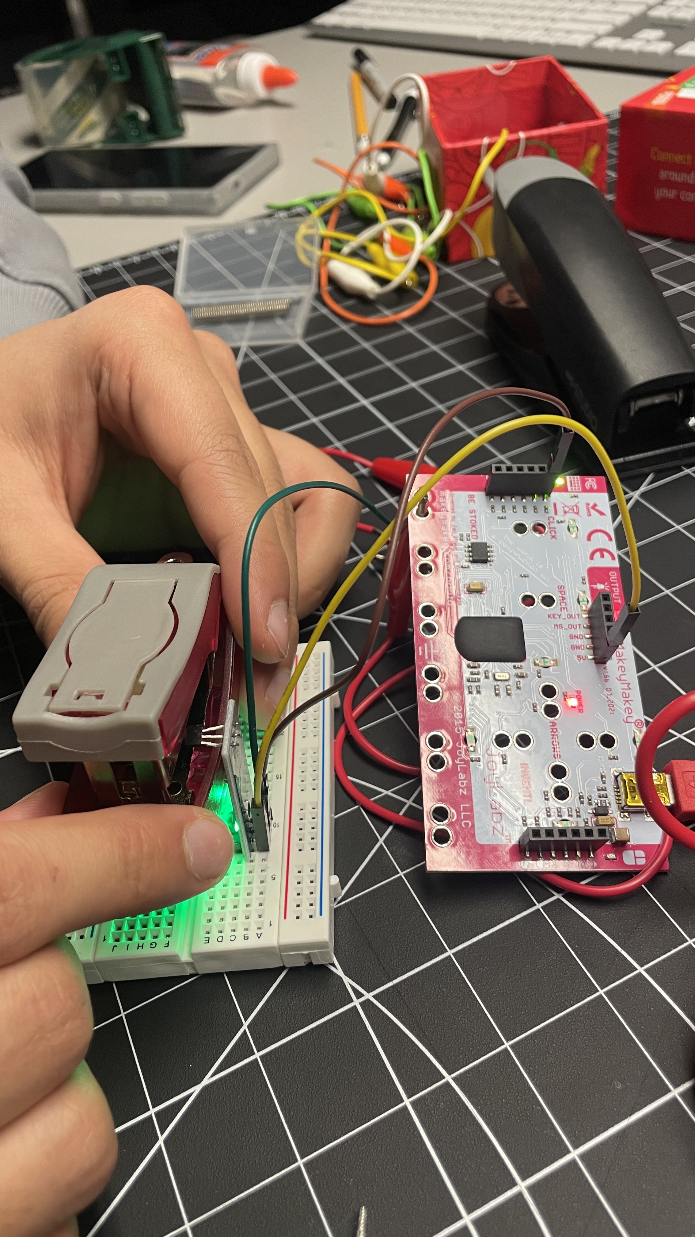 Metal stapler body causing magnetic interference, leading to a repositioned layout — sensor moved to the side gap and magnet to the top to reduce interference and improve reliability