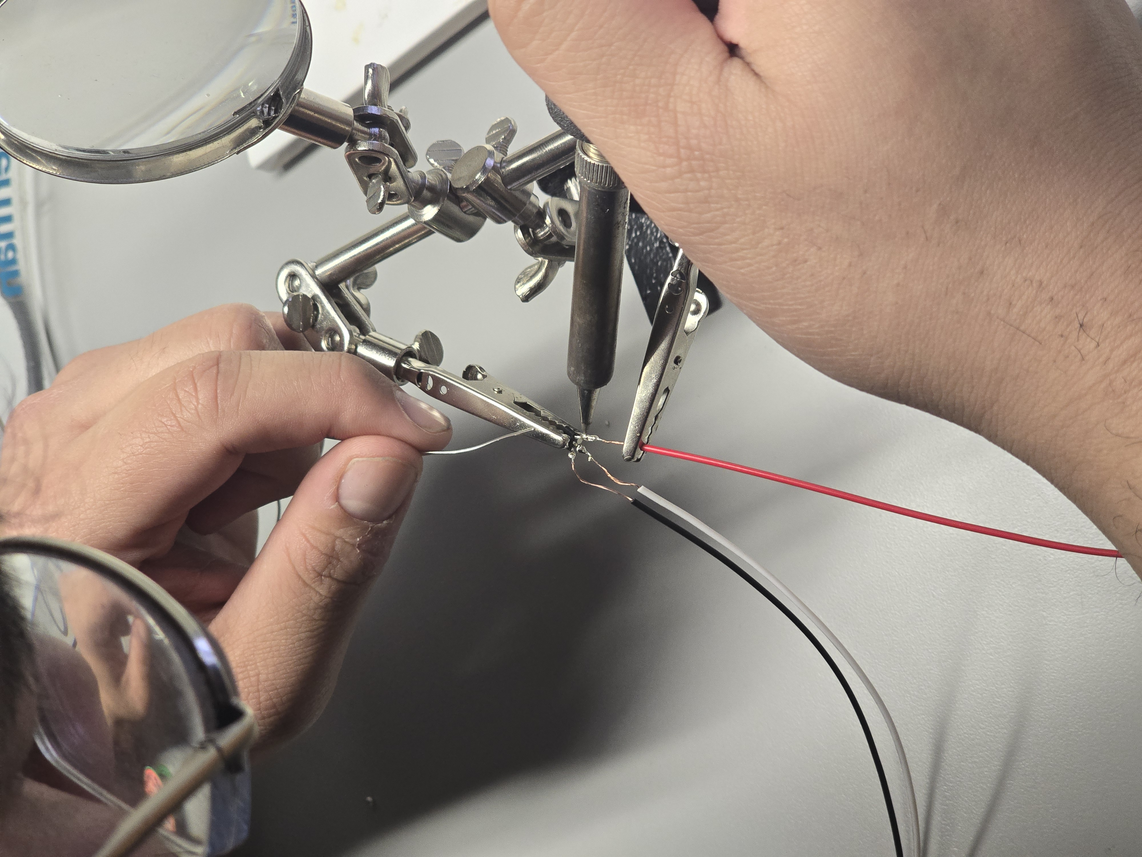 Hands soldering Hall sensor extension wires